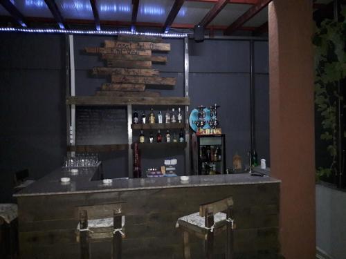 a bar with two chairs and a counter with alcohol at Villa Del Mar in Gonio