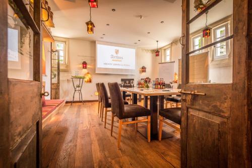 a dining room with a table and chairs at Hotel Arthus in Aulendorf