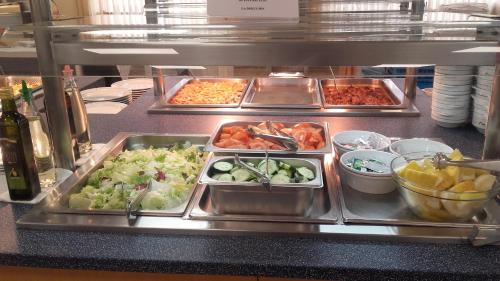 a buffet line with many trays of food at Balneario de Ledesma in Vega de Tirados