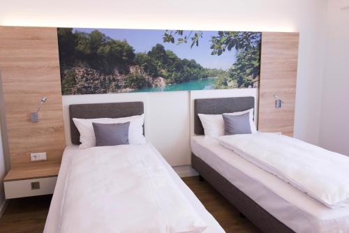 Ένα ή περισσότερα κρεβάτια σε δωμάτιο στο Boardinghouse am Teuto