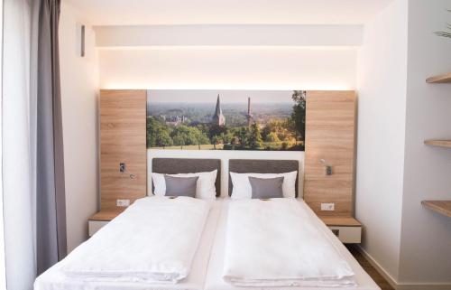 Ένα ή περισσότερα κρεβάτια σε δωμάτιο στο Boardinghouse am Teuto