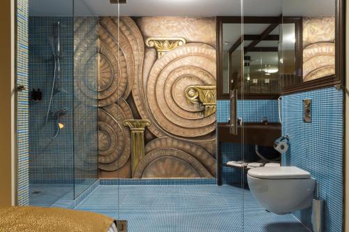 a bathroom with a shower with a large wooden wall at Ganzo Boutique Hotel in Bucharest