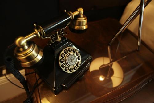 an old fashioned phone sitting on a table at The Belhaven Hotel in Glasgow