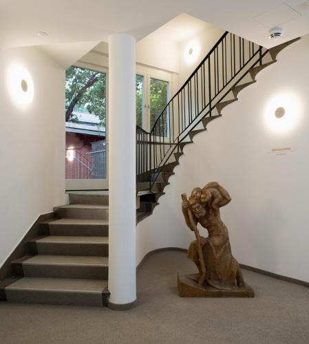 a staircase with a statue in front of a stair case at Hotel Christophorus in Berlin