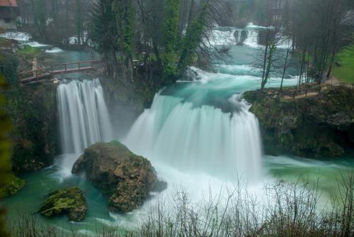 a waterfall in the middle of a river at Apartment Kolaković in Slunj