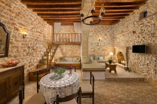 a room with a table and chairs in a building at Rodia House in Lardos