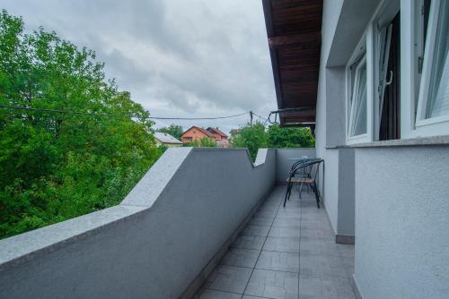 a balcony with a table and a chair on a building at Apartment Kolaković in Slunj