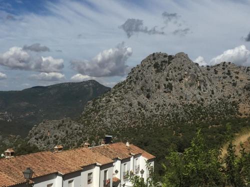 a mountain in the distance with houses in front at Posada El Parral in Benaocaz