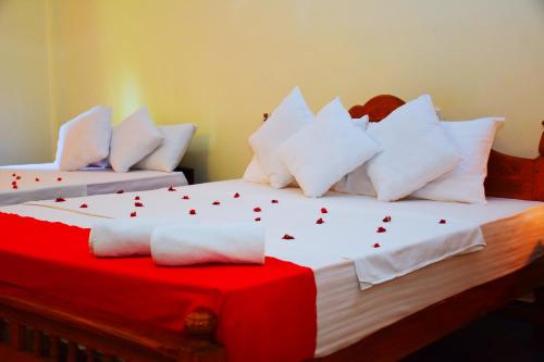 a bedroom with two beds with white pillows at Mount View in Polonnaruwa