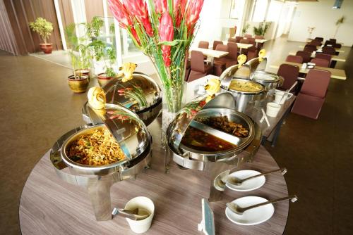 a table with several trays of food on it at Meize City Center Bandung in Bandung