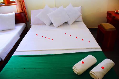 a bedroom with a bed with two pillows on it at Mount View in Polonnaruwa