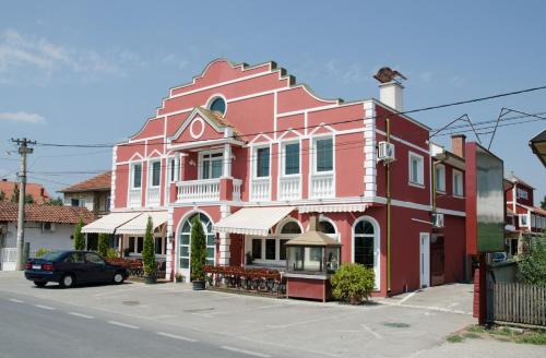 a large red building on the side of a street at Hotel Drumski Raj in Svilajnac