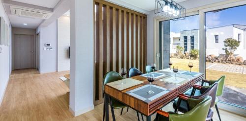 a dining room with a table and chairs at Happiness Pension in Jeju