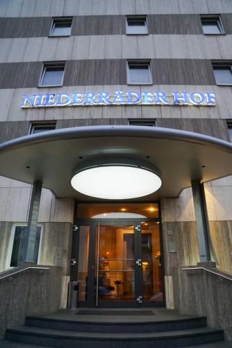 a building with a sign on the front of it at Hotel Niederräder Hof in Frankfurt/Main