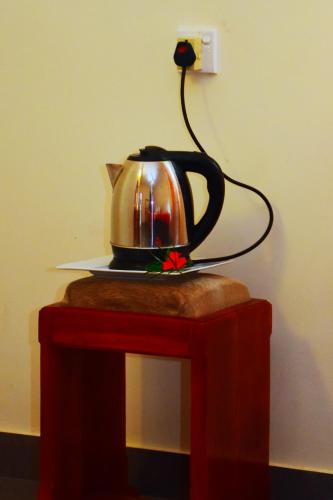 a tea kettle on a plate on a table at Mount View in Polonnaruwa