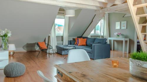 a living room with a blue couch and a table at Hotel & Restaurant Sonne in Kirchzarten