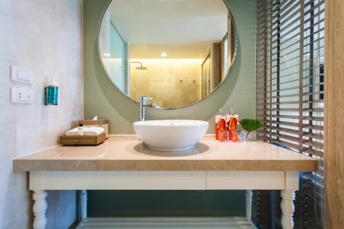 a bathroom with a sink and a mirror at Amari Hua Hin in Hua Hin