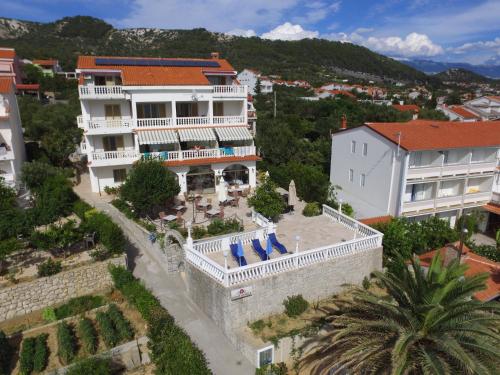 an aerial view of a house with a swimming pool at Apartments and Rooms Vinko in Barbat na Rabu