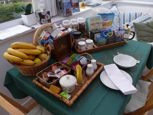 una mesa con una cesta de comida y plátanos en ella en Cosy Twin Room in Brecon, en Brecon