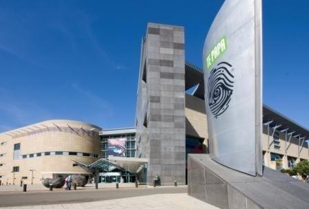 a large building with a sign in front of it at Quest On Lambton Serviced Apartments in Wellington