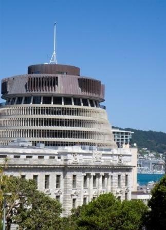 a large white building with a tower on top of it at Quest On Lambton Serviced Apartments in Wellington