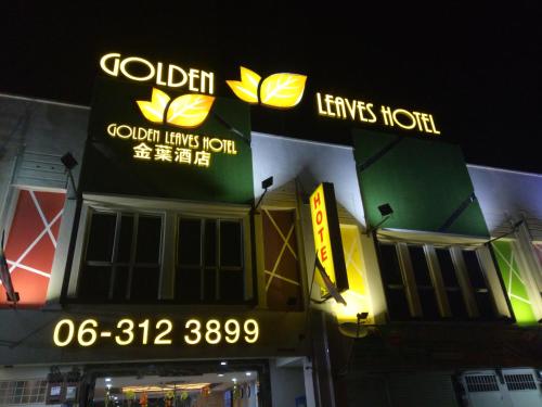 a store with neon signs on the side of a building at Golden Leaves Hotel in Malacca