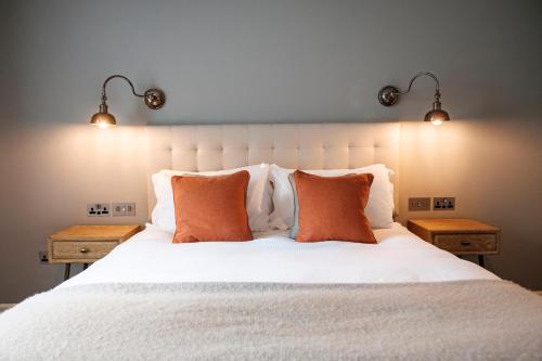 a bedroom with a white bed with two night stands at The Princess Royal in Farnham