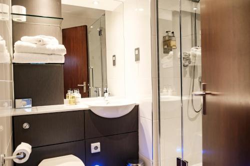 a bathroom with a sink and a glass shower at The Princess Royal in Farnham
