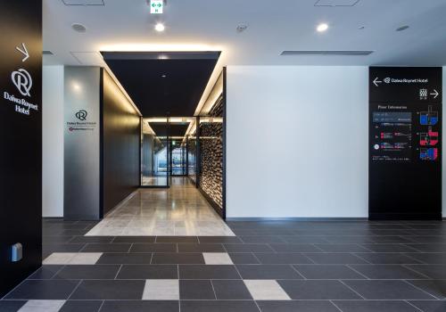 a hallway in a building with a tile floor at Daiwa Roynet Hotel Koriyama Ekimae in Koriyama