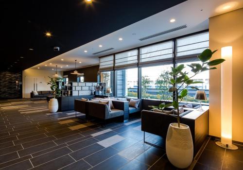 a lobby with couches and a large window at Daiwa Roynet Hotel Koriyama Ekimae in Koriyama