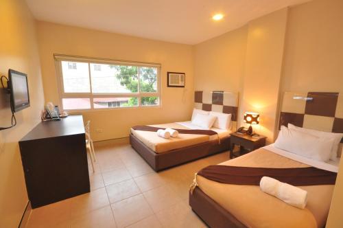Grande Vista Hotel tesisinde bir odada yatak veya yataklar