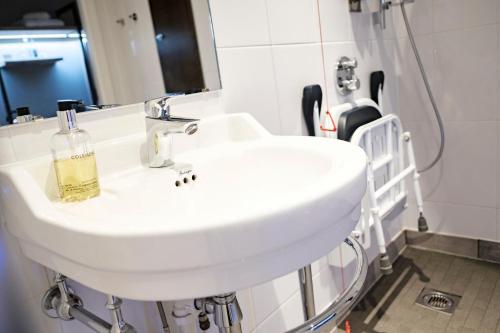 a white sink in a bathroom with a mirror at The Princess Royal in Farnham
