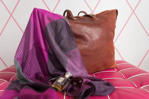 a purse sitting on top of a couch at Palazzo Ferraioli - Hotel & Wellness in Atrani