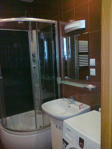 a bathroom with a shower and a sink and a toilet at Apartamenty w Karkonoszach in Miłków