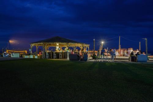 a gazebo at night with a crowd of people at Dion Palace Resort and Spa in Limani Litochorou