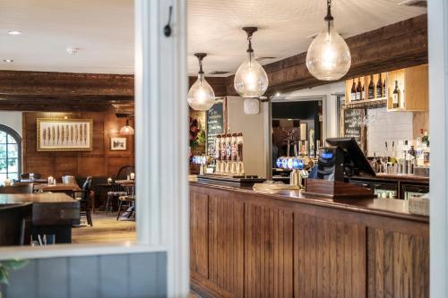 a view of a bar with pendant lights at The Princess Royal in Farnham