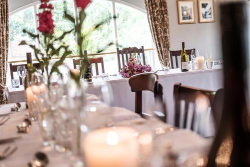 a long table with glasses and flowers on it at The Princess Royal in Farnham