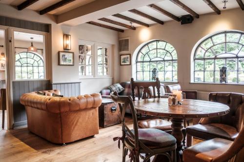 a living room with a table and chairs at The Princess Royal in Farnham