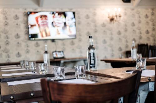a table in a restaurant with a bottle on the wall at The Princess Royal in Farnham