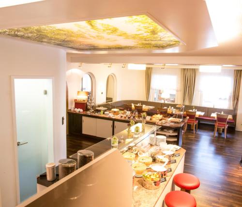 a kitchen with a buffet of food on a table at Hotel Krone in Pforzheim