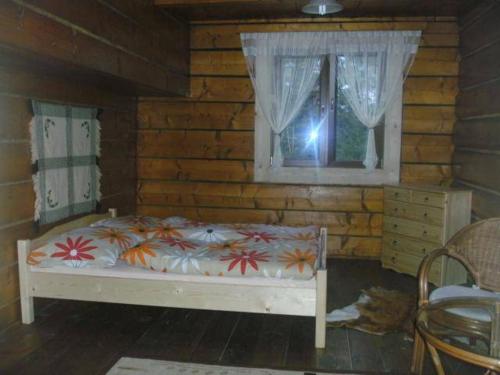 a bed in a room with a window at u Piwowara in Kościelisko