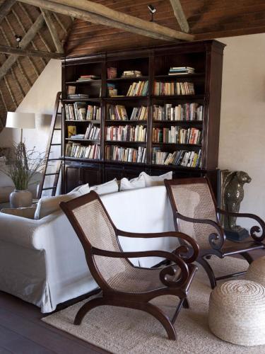 a living room with a couch and a book shelf at Tutwa Desert Lodge in Augrabies