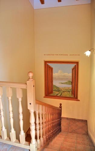 a staircase in a house with a painting on the wall at La Zerla in Bardolino