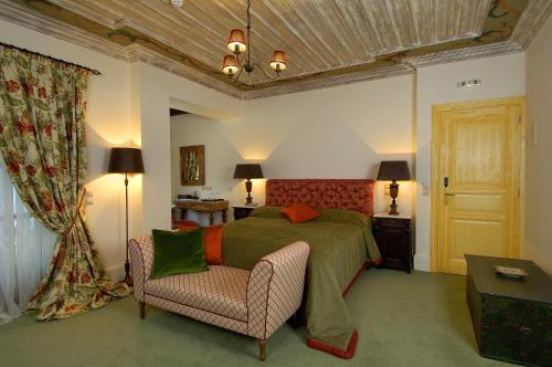 a bedroom with a bed and a couch and a chair at Emotions Country Resort in Voútiron