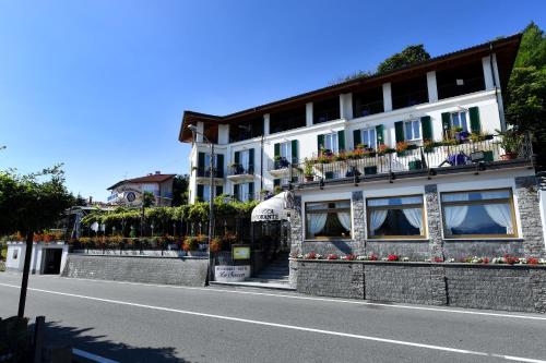 a building with flower boxes on the side of a street at Hotel La Sacca in Stresa