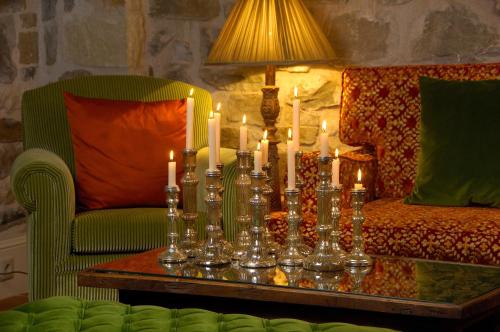 a living room with a table with candles on it at Emotions Country Resort in Voútiron