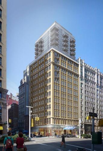 a tall building with people walking in front of it at Hotel Park Ave NYC in New York