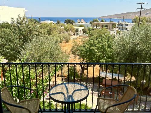 a table and chairs on a balcony with a view of the ocean at Castellania Hotel Apartments in Livadia