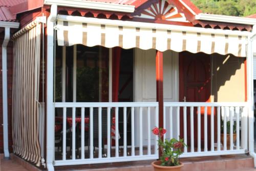 a porch with an awning on a house at Gites Les Sandragons in Saint-Claude