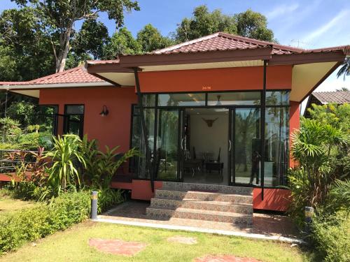 a small house with glass doors and a staircase at Saree Lagoon Villa Koh Samui in Lipa Noi